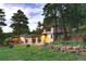 Charming single Gathering home nestled amongst trees and rock landscaping, featuring a cozy covered porch at 150 Hess Ave, Golden, CO 80401
