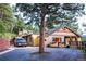 Inviting front exterior with a charming porch and natural landscaping with a big tree at 150 Hess Ave, Golden, CO 80401