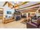 Open living space with stone fireplace and wood beam ceiling at 150 Hess Ave, Golden, CO 80401
