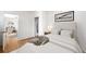 Cozy bedroom with comfortable bed, hardwood floors, and access to the living room at 215 E 11Th Ave # D5, Denver, CO 80203