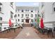 Inviting courtyard with outdoor seating, red umbrellas, and charming brick pathways at 215 E 11Th Ave # D5, Denver, CO 80203