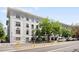 Charming white apartment building with manicured lawn and a variety of mature trees at 215 E 11Th Ave # D5, Denver, CO 80203