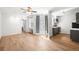 Bright living room features wood floors, modern lighting, and convenient access to the kitchen and the balcony at 215 E 11Th Ave # D5, Denver, CO 80203