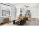 Bright living room featuring a ceiling fan, stylish decor, and a breakfast bar with sleek counter stools at 215 E 11Th Ave # D5, Denver, CO 80203