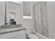 Cozy bathroom featuring a granite vanity top and a shower with patterned curtain at 20999 E Quincy Dr, Aurora, CO 80015