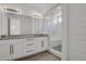 Modern bathroom with double vanity, granite countertop, and glass enclosed shower with marble tiling at 20999 E Quincy Dr, Aurora, CO 80015