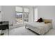 Bright bedroom with large windows providing natural light and street views, plus a comfortable bed at 20999 E Quincy Dr, Aurora, CO 80015