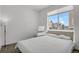 Bright bedroom with a large window, simple decor, and a comfortable bed creating a serene living space at 20999 E Quincy Dr, Aurora, CO 80015