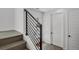 Entryway with wood floors, modern railing, and white interior doors at 20999 E Quincy Dr, Aurora, CO 80015