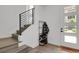 Bright entryway with wood floors, stairs, coat rack, and modern decor at 20999 E Quincy Dr, Aurora, CO 80015