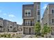 Modern gray three-story home with stone accents and a small balcony at 20999 E Quincy Dr, Aurora, CO 80015