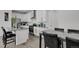 Open kitchen with white cabinets, stainless steel appliances, granite counters, and a center island with barstools at 20999 E Quincy Dr, Aurora, CO 80015