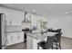 Bright kitchen showcasing white cabinets, a stainless steel range hood, and a granite-topped island with bar seating at 20999 E Quincy Dr, Aurora, CO 80015