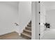 Bright stairway featuring hardwood steps with white trim and access to an upper level office at 20999 E Quincy Dr, Aurora, CO 80015