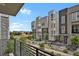 Exterior view from balcony of modern townhomes featuring clean architectural lines, landscaping, and a community atmosphere at 20999 E Quincy Dr, Aurora, CO 80015