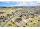 Wide aerial view of a suburban community with manicured lawns and streets at 23440 E Rockinghorse Pkwy, Aurora, CO 80016