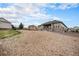 Scenic view of the backyard, complete with a covered patio, landscaped area, and neighborhood surroundings at 23440 E Rockinghorse Pkwy, Aurora, CO 80016