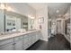 Well-appointed bathroom featuring double sinks, sleek cabinetry, and a walk-in shower for a spa-like experience at 23440 E Rockinghorse Pkwy, Aurora, CO 80016
