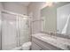 Bathroom with a tile shower and a vanity featuring a granite countertop and stylish fixtures at 23440 E Rockinghorse Pkwy, Aurora, CO 80016