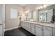 Elegant bathroom featuring a double vanity with granite countertops and modern fixtures at 23440 E Rockinghorse Pkwy, Aurora, CO 80016