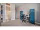 Bedroom featuring an attached bath with tile shower, blue cabinets, and a desk area for work or hobbies at 23440 E Rockinghorse Pkwy, Aurora, CO 80016
