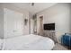 Bright bedroom with a cozy bed, a TV and dresser, and a double closet, creating a relaxing retreat at 23440 E Rockinghorse Pkwy, Aurora, CO 80016