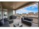 Covered deck with comfortable seating area and grill; perfect for outdoor entertaining and relaxation at 23440 E Rockinghorse Pkwy, Aurora, CO 80016