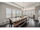 Dining room with a rustic wood table and bench seating beneath a chandelier and plenty of natural light at 23440 E Rockinghorse Pkwy, Aurora, CO 80016