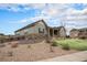 Exterior view of a well-maintained home showcasing the beautiful landscaping and private backyard at 23440 E Rockinghorse Pkwy, Aurora, CO 80016