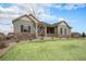 Beautifully landscaped home with a well-kept lawn and a welcoming front porch, perfect for relaxing at 23440 E Rockinghorse Pkwy, Aurora, CO 80016