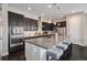 Modern kitchen with stainless steel appliances, dark cabinetry, and a spacious island with seating at 23440 E Rockinghorse Pkwy, Aurora, CO 80016