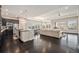 Expansive open-concept living space showcasing the kitchen, dining area, and living room with natural light at 23440 E Rockinghorse Pkwy, Aurora, CO 80016