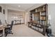 Well-lit office featuring a large shelving unit, a desk, and a comfortable chair at 23440 E Rockinghorse Pkwy, Aurora, CO 80016