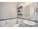 Charming powder room featuring a stylish sink, decorative mirror, and wall decor at 23440 E Rockinghorse Pkwy, Aurora, CO 80016