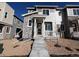 Modern two-story townhome with stone accents, a covered porch, and a well-maintained front yard at 6628 N Nepal Ct, Aurora, CO 80019