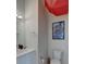 Modern powder room featuring a white vanity, toilet, and a Beatles-themed art piece at 5125 W 29Th Ave # 1, Denver, CO 80212