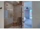 Beautiful tile shower with glass door, a built-in seat, and a glimpse into the luxurious bedroom at 5125 W 29Th Ave # 1, Denver, CO 80212