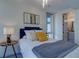 Bedroom with modern fixtures, comfortable bed, and adjacent bathroom at 5125 W 29Th Ave # 1, Denver, CO 80212