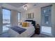 Bright bedroom with large windows, city views, and modern light fixture at 5125 W 29Th Ave # 1, Denver, CO 80212
