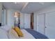 Serene bedroom with cozy bedding, access to the en-suite bathroom, and additional storage options at 5125 W 29Th Ave # 1, Denver, CO 80212