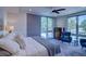 Bright bedroom with large windows, ceiling fan, comfortable seating, and a cozy bed with plush pillows at 5125 W 29Th Ave # 1, Denver, CO 80212