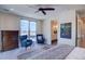 Bright bedroom features cityscape views, two blue chairs, and a ceiling fan at 5125 W 29Th Ave # 1, Denver, CO 80212