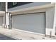 Attached garage with a grey door on a modernly designed house at 5125 W 29Th Ave # 1, Denver, CO 80212