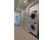 Convenient laundry area with stacked washer and dryer, easily accessible from the hallway at 5125 W 29Th Ave # 1, Denver, CO 80212