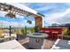 Relax on this rooftop deck with a fire pit, bar, seating, and city views at 5125 W 29Th Ave # 1, Denver, CO 80212