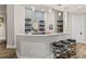 Inviting bar area with sleek countertops, floating shelves, and modern stools at 937 Aztec Dr, Castle Rock, CO 80108