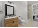 Modern bathroom features sleek wood cabinetry, a minimalist mirror, and glass-enclosed shower at 937 Aztec Dr, Castle Rock, CO 80108
