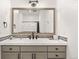Well-lit bathroom vanity with decorative tile and large framed mirror reflecting the shower at 937 Aztec Dr, Castle Rock, CO 80108