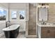 Stylish bathroom with a freestanding tub, walk-in shower, and large windows offering scenic views at 937 Aztec Dr, Castle Rock, CO 80108