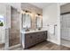 Luxurious bathroom featuring a double vanity, stone accent wall, and a walk-in shower at 937 Aztec Dr, Castle Rock, CO 80108
